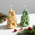 Two castle candle samples with circular bases beside Christmas ornaments