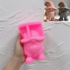 Pink silicone ghost hat gnome mold held in a hand