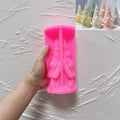 Pink silicone tree cottage mold beside example castings