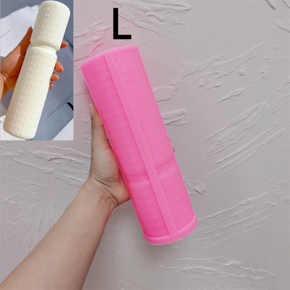 Pink Large waisted pillar silicone mold beside a casting