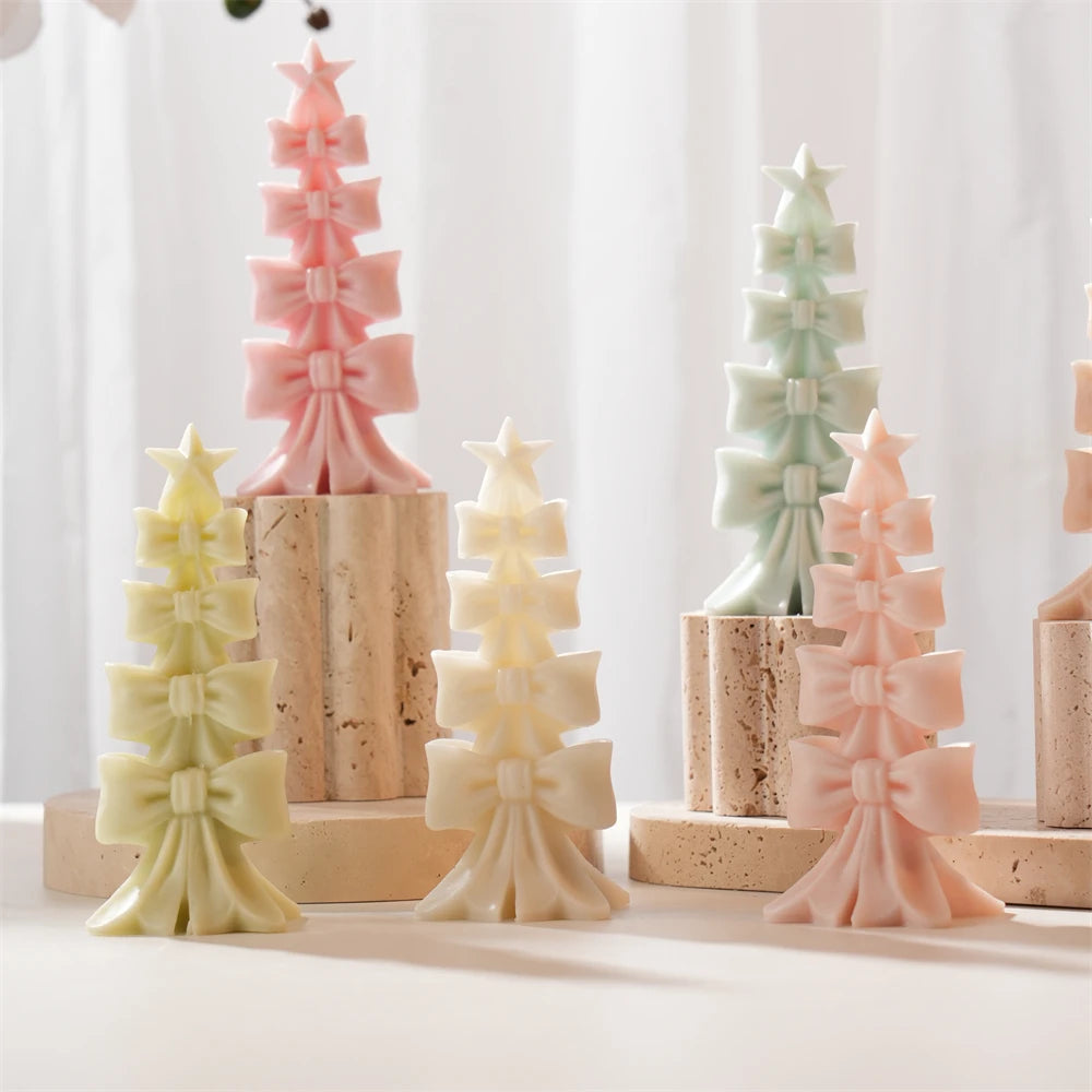 Bow-shaped Christmas tree candle castings on wooden display stands