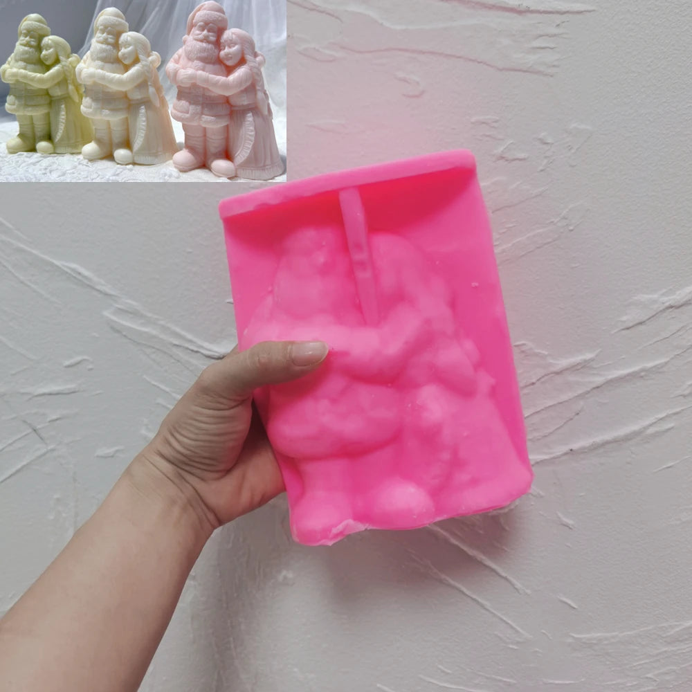 Pink silicone Santa couple mold held beneath example castings