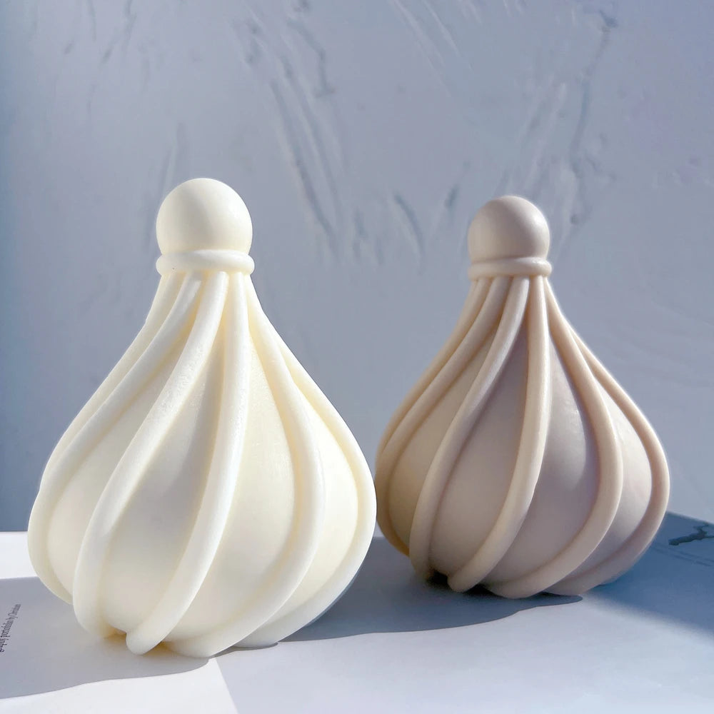 Front view of bulb-shaped candles with sweeping raised ribs