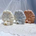 Three carnival mask decorative castings with raised plume details