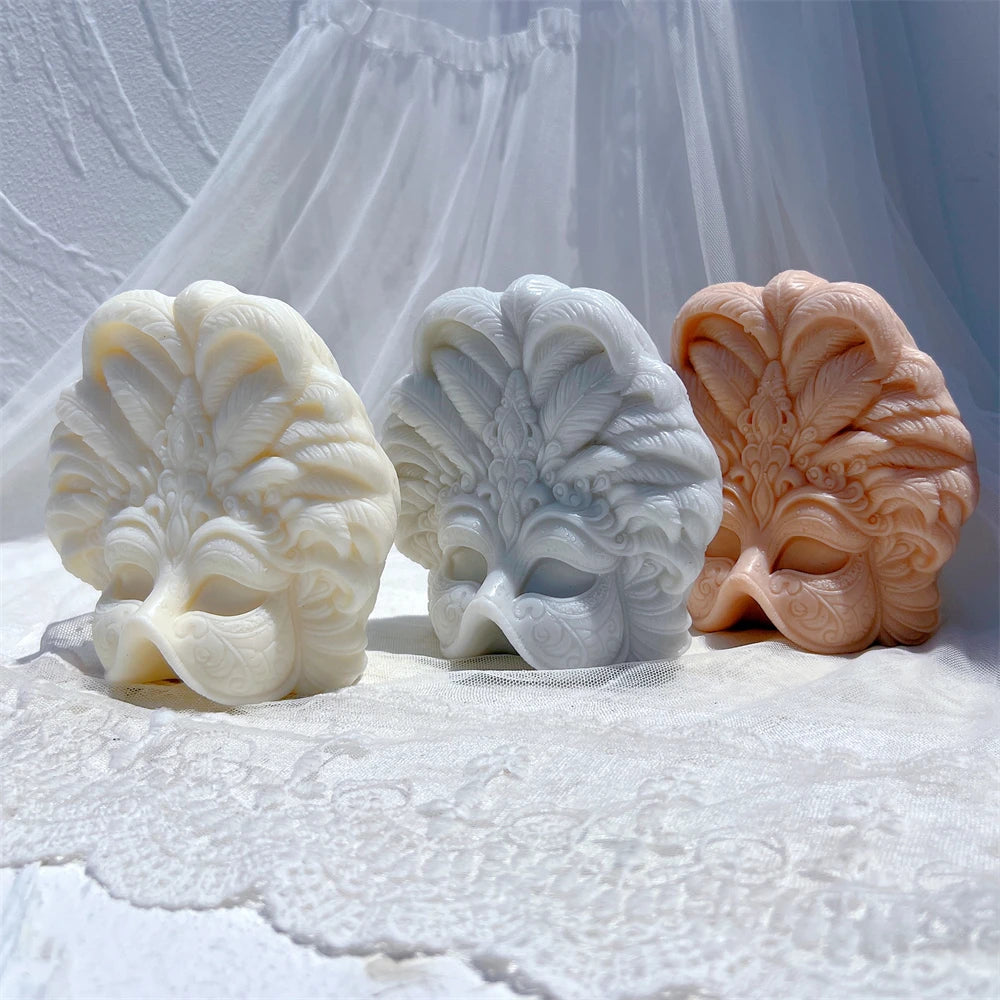 Three carnival mask decorative castings with raised plume details