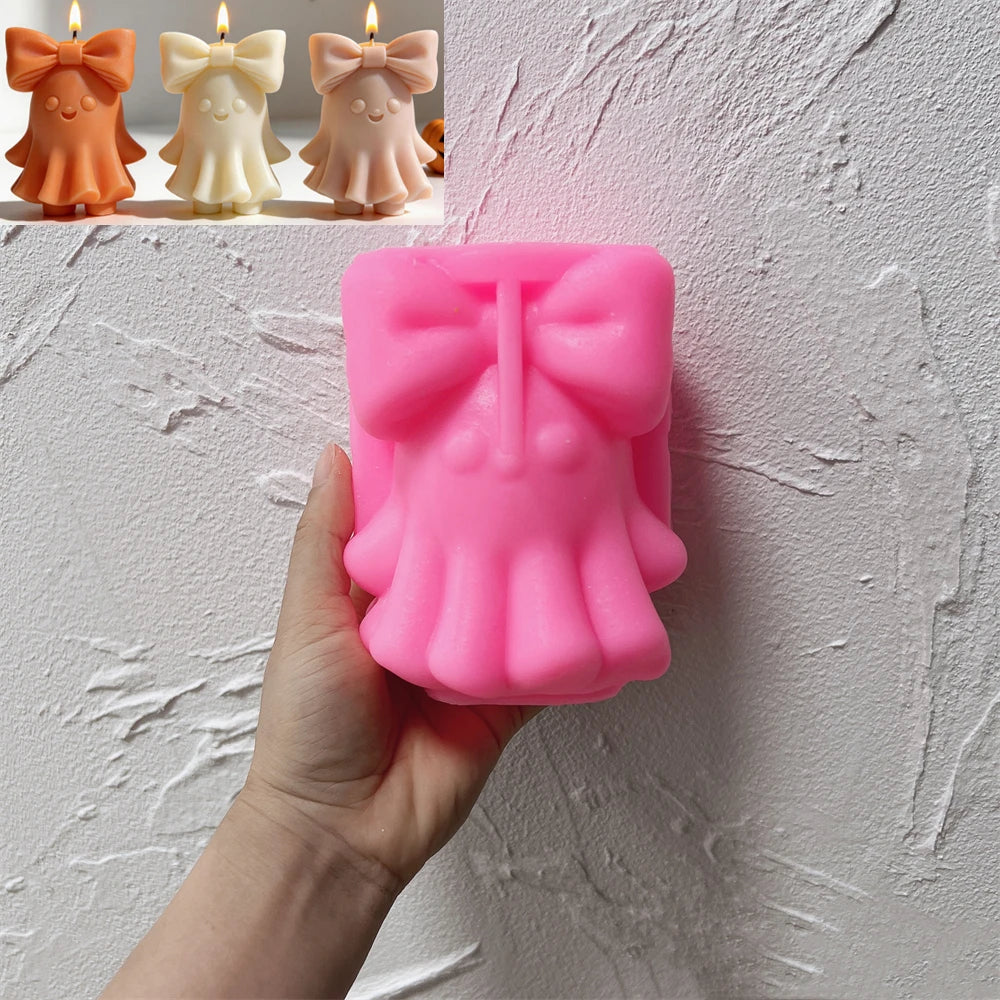 Pink large-bow ghost silicone mold held in one hand