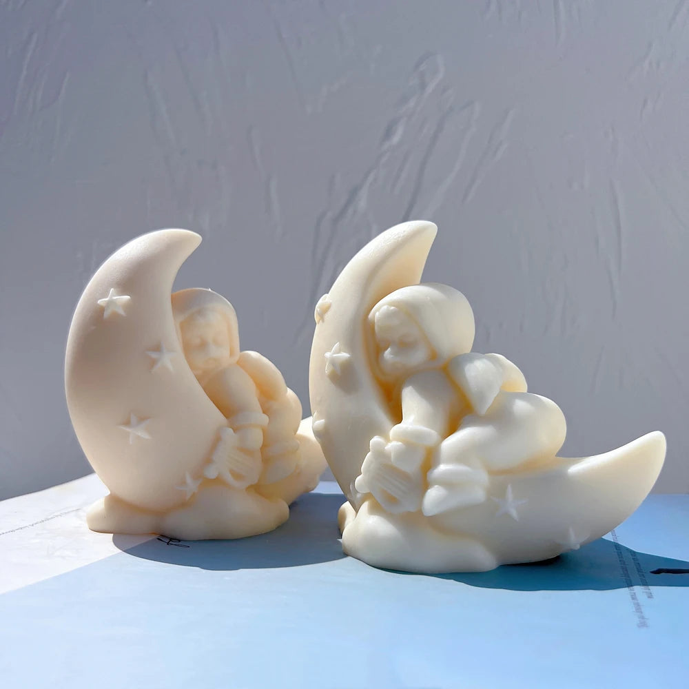 Ivory angel and moon castings on rounded cloud bases