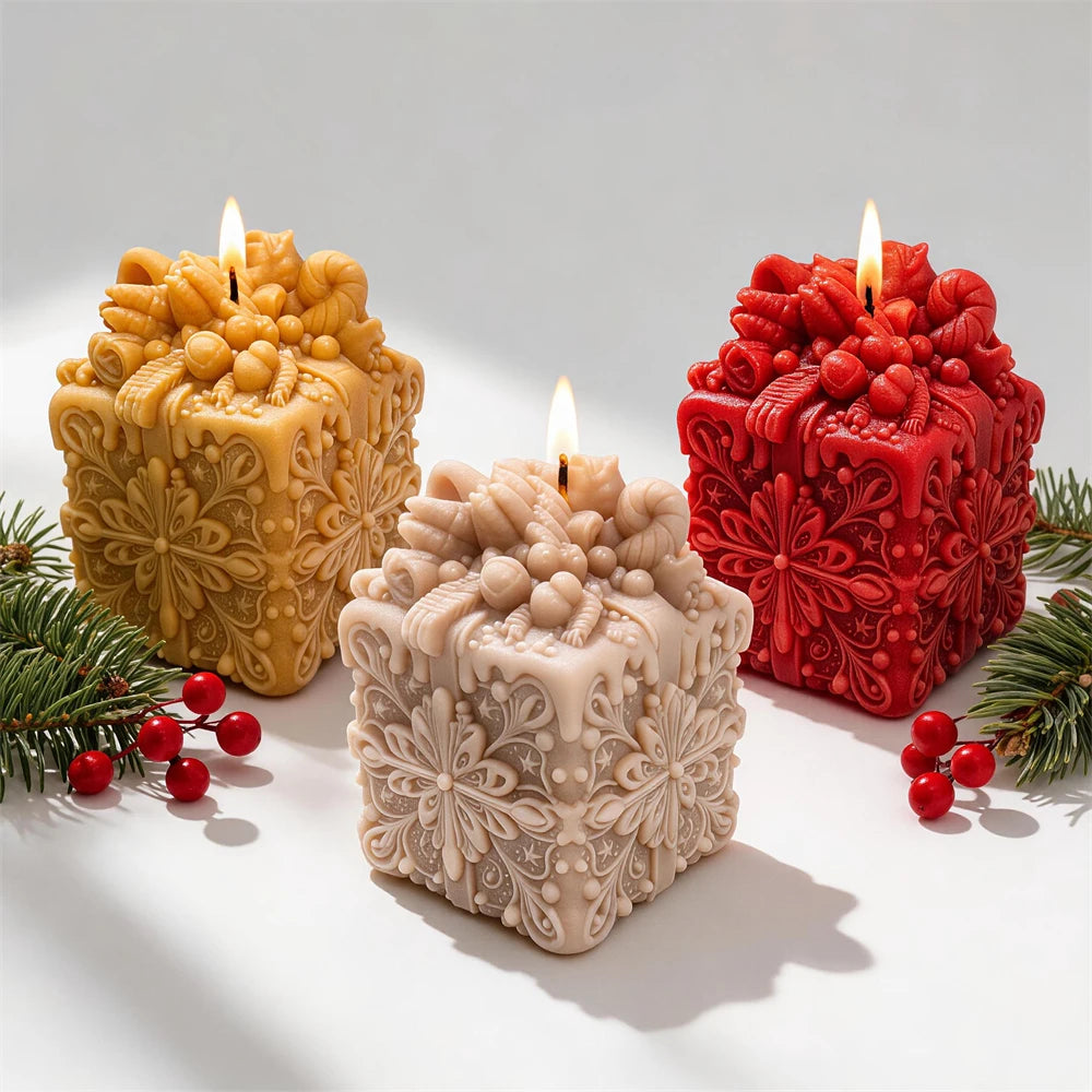Gold red and cream gift-box candles with clustered festive tops