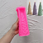 Pink silicone star topped fir tree mold held in a hand