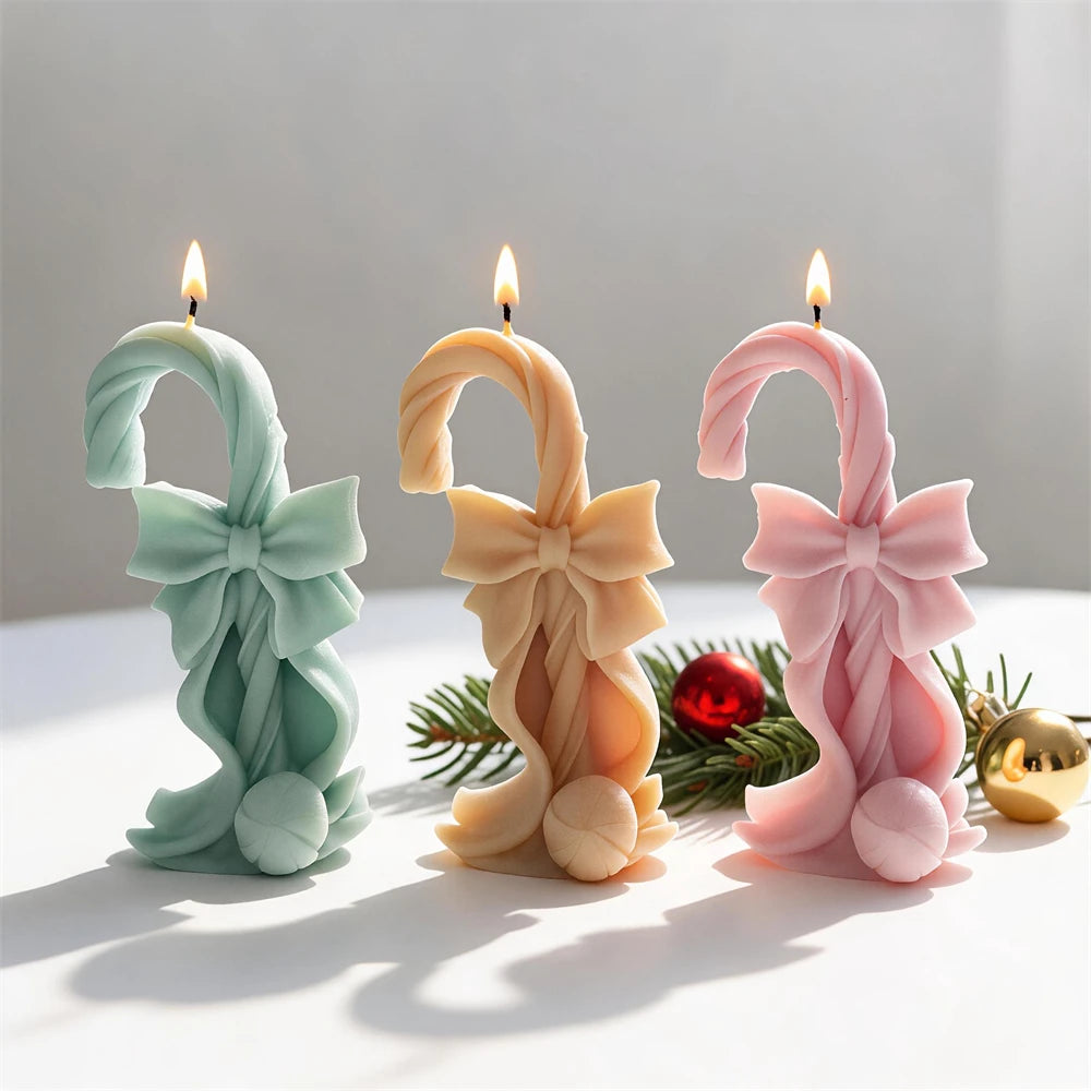 Bow-tied candy cane candles in green peach and pink