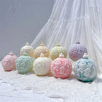 Five Christmas bauble candle designs displayed in pastel colors