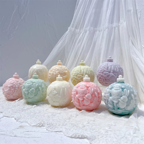 Five Christmas bauble candle designs displayed in pastel colors