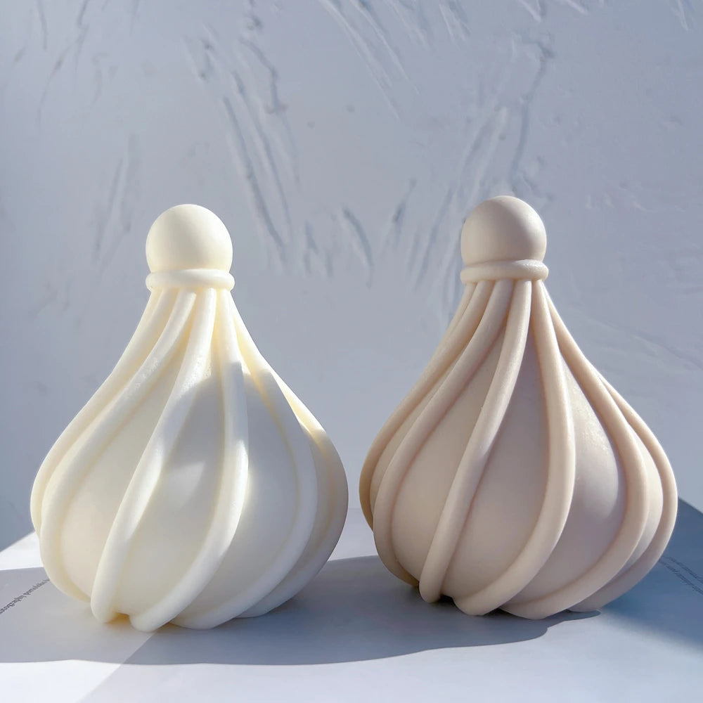 Cream and taupe spiral-ribbed droplet candles side by side