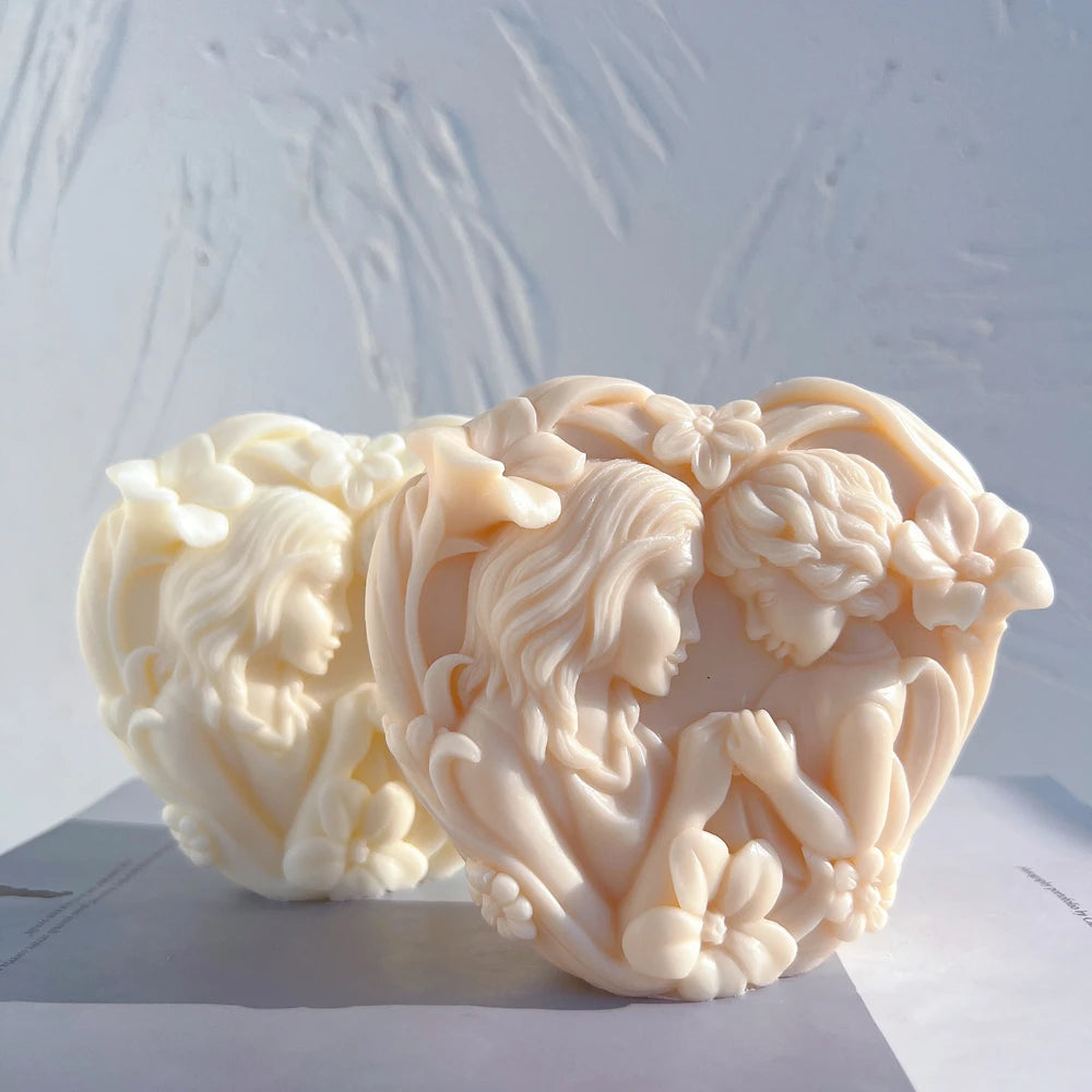 Mother and baby sculptural relief casting in a heart-like composition