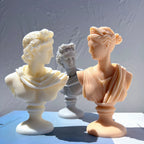 Cream and peach bust sculptures with sculpted hair and pedestal bases
