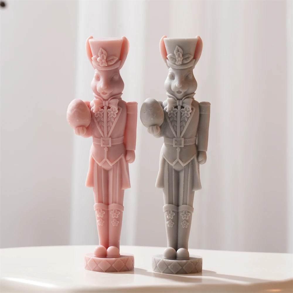Front view of pink and gray rabbit nutcracker figures