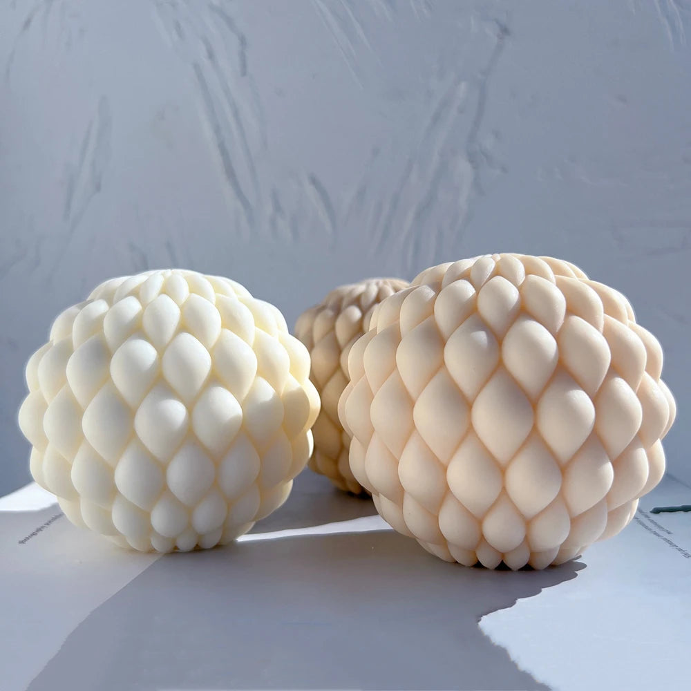 Angled view of cream and peach teardrop-scale castings