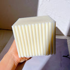 Side view of a square ribbed candle casting