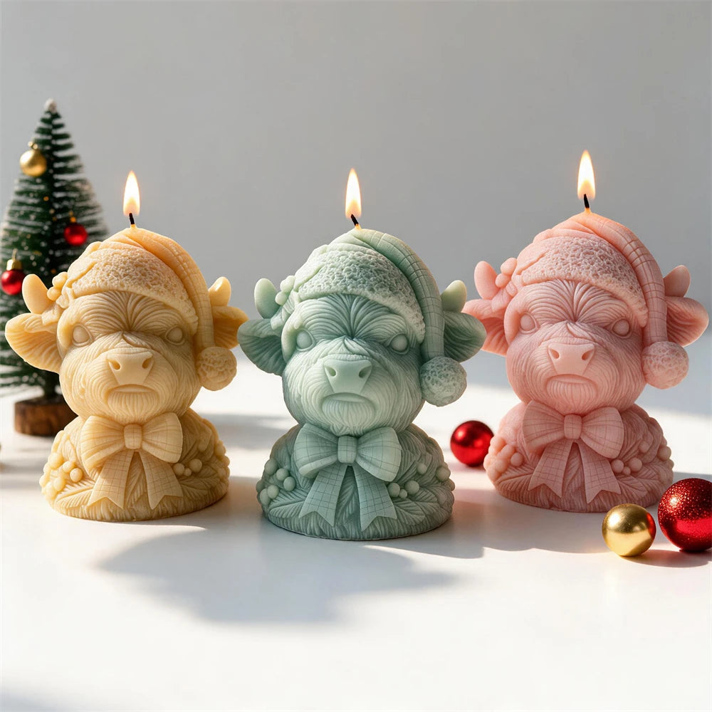 Three festive Highland cow castings in pastel colors