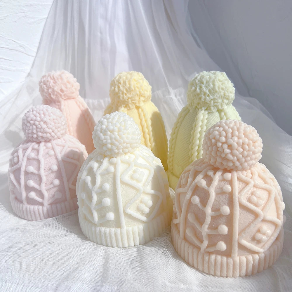 Front view of geometric and cable-knit hat castings with ribbed cuffs