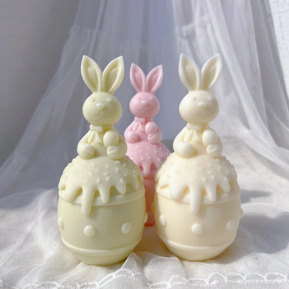 Bunnies seated on banded eggs with raised dot decorations
