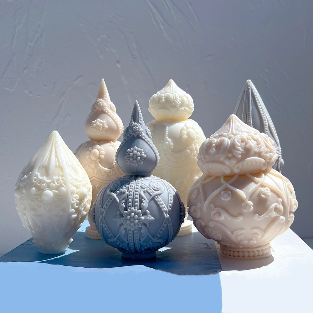Six decorative finial castings with floral and bead-like surface patterns