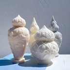 Tall urn-shaped castings beside floral double-bulb designs