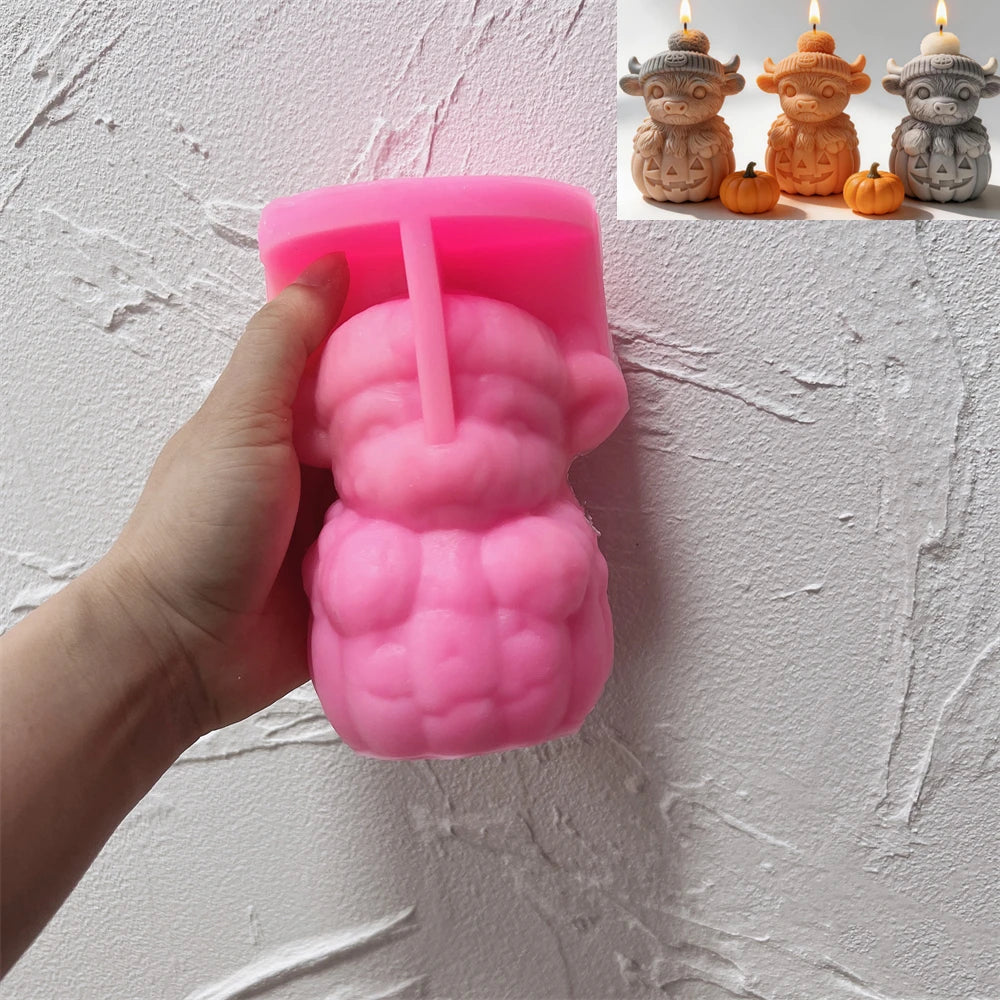 Pink Highland cow pumpkin silicone mold held in one hand