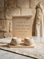 Close view of Hebrew-inscribed scroll plaque with rolled top and broad flat base