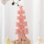 Pink bow-tier tree casting topped with a five-point star