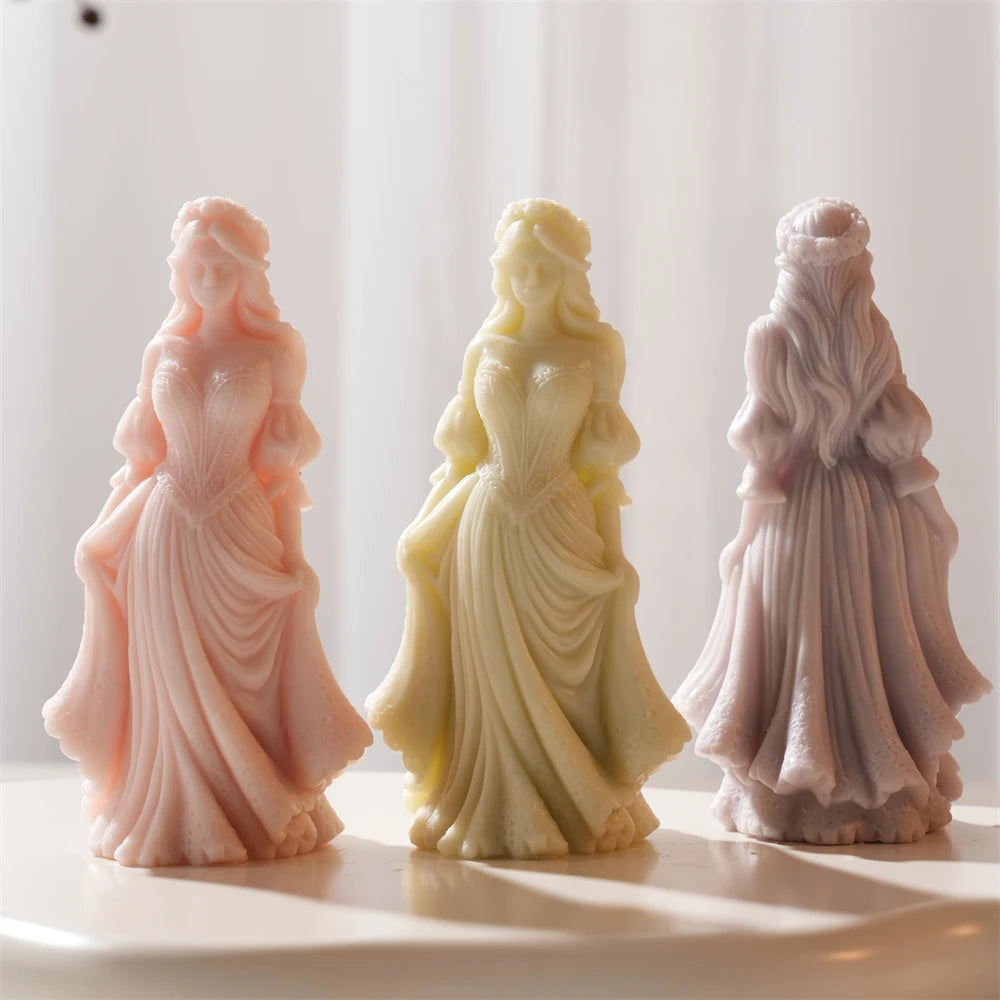 Full-length lady candle sculptures showing folds of the gown