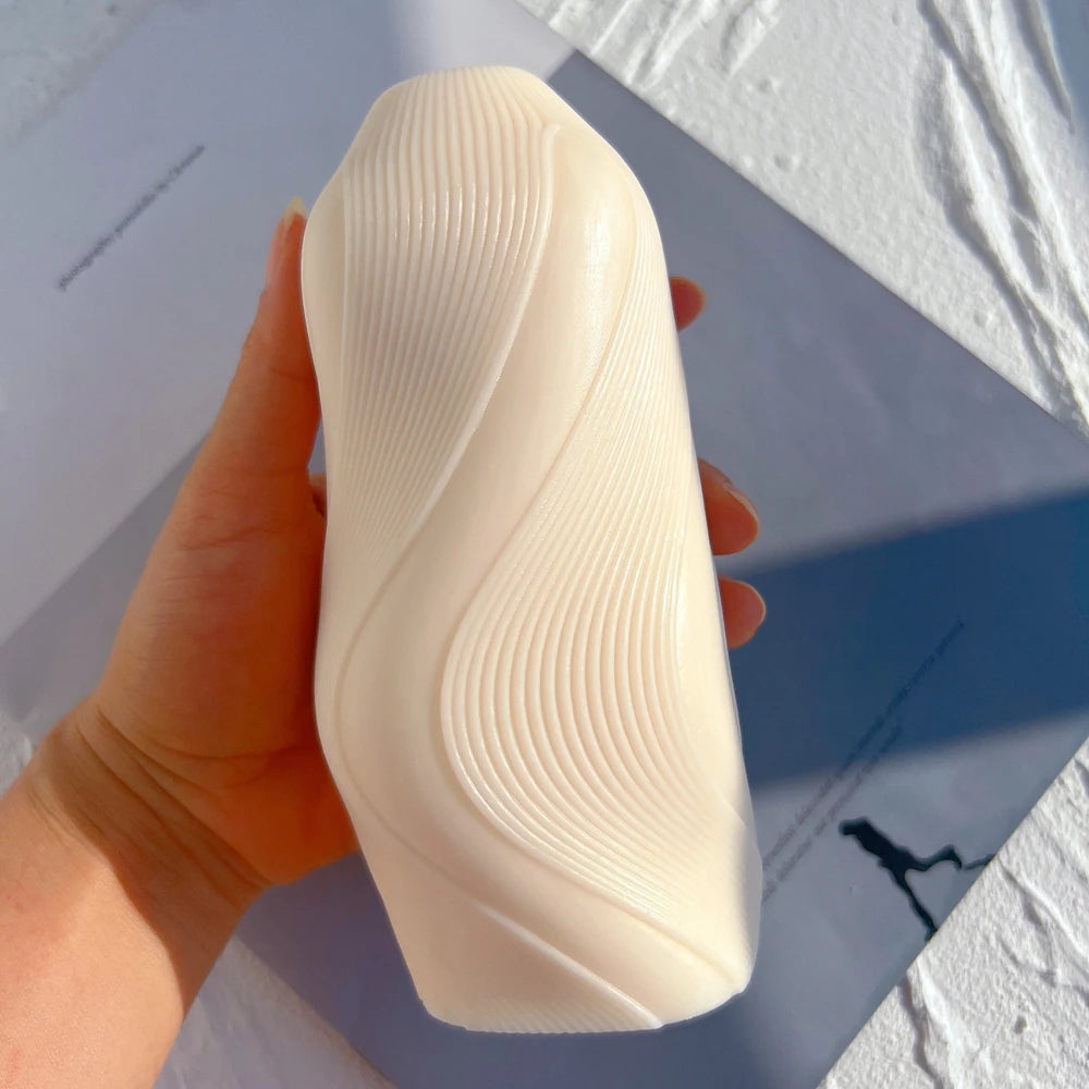 Cream flowing-wave casting held in one hand