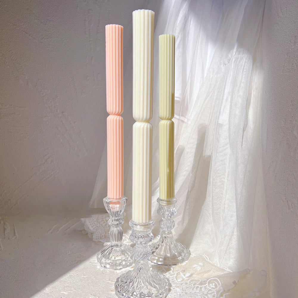 Three ribbed taper castings staged in glass holders