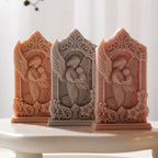 Three framed mother-and-baby angel relief candle castings