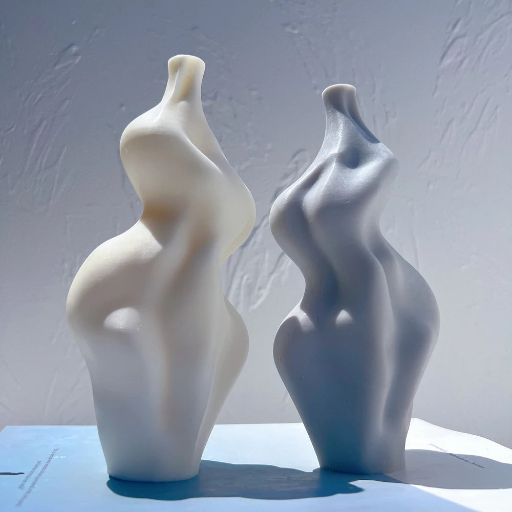 Smooth sculptural candles with swelling and recessed curves