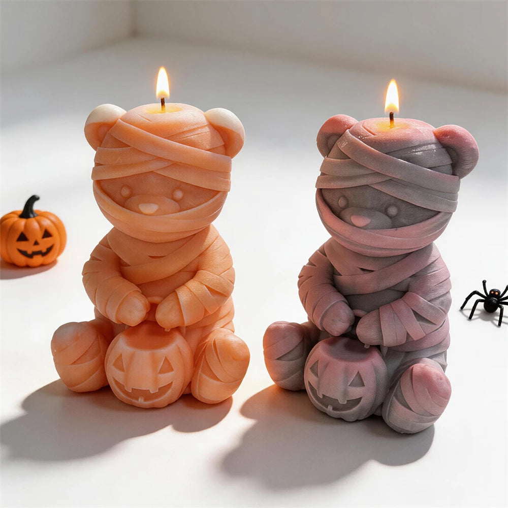 Two seated mummy bear castings with layered wraps