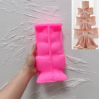 Pink silicone stacked bow candleholder mold held open