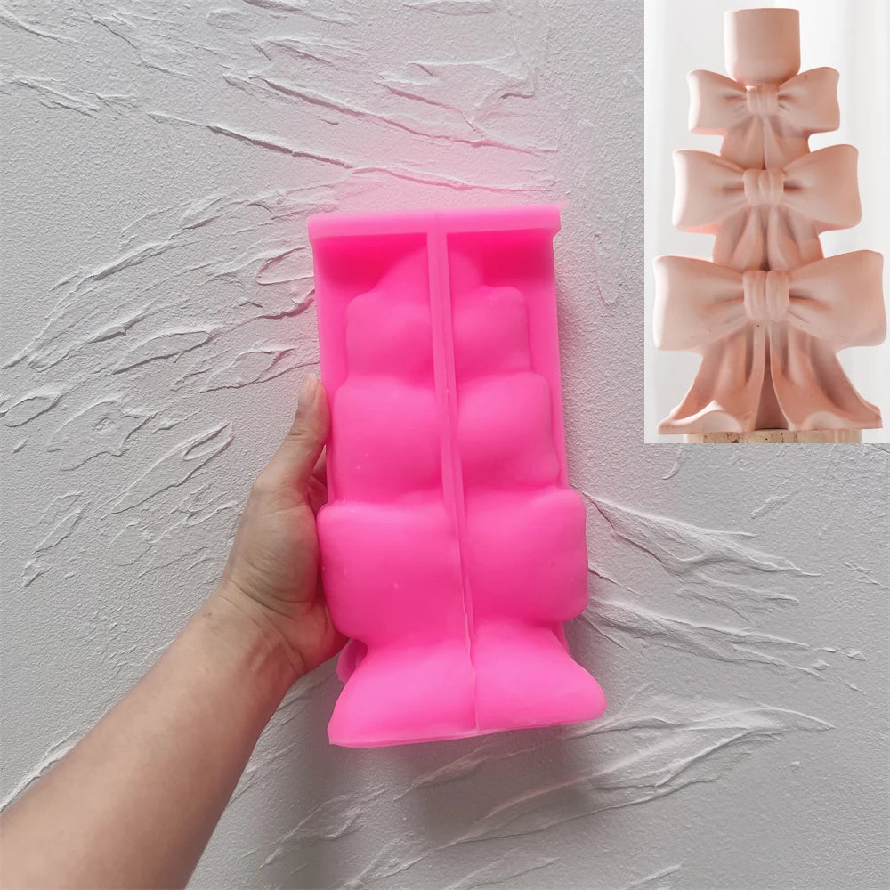 Pink silicone stacked bow candleholder mold held open