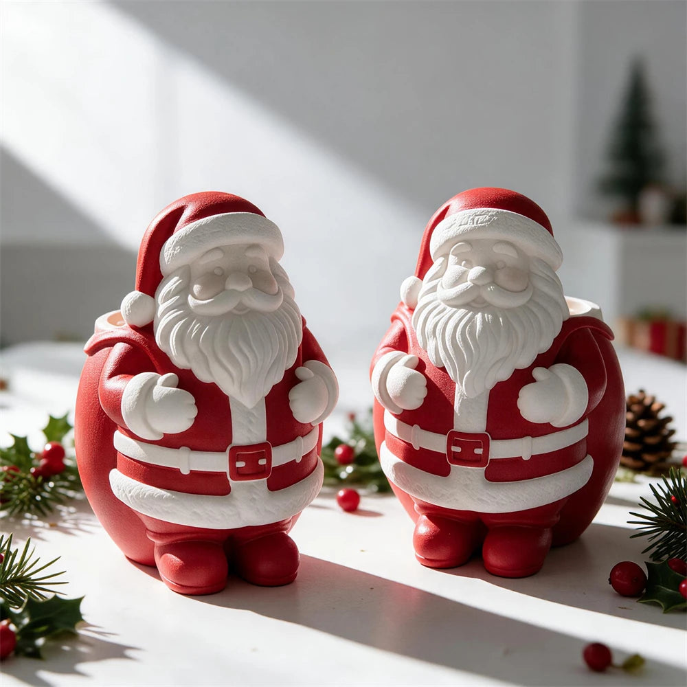 Two festive Santa figure castings with raised hats and textured beards