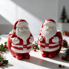 Two festive Santa figure castings with raised hats and textured beards