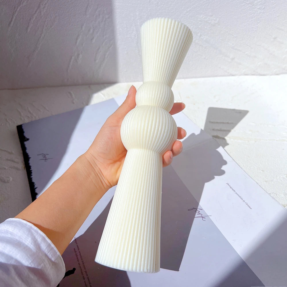 Double-sphere sculptural casting held in one hand
