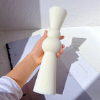 Double-sphere sculptural casting held in one hand