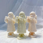 Standing Santa figures with raised decorative details