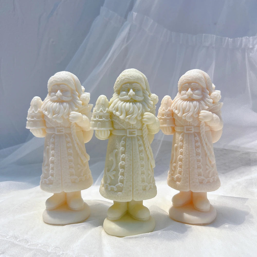 Standing Santa figures with raised decorative details