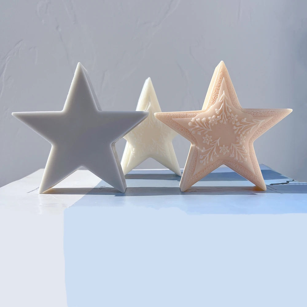 Front view of gray and peach five-point star candle samples