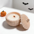Open knitted pumpkin container with its lid resting beside it