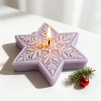 Close view of purple floral star candle with a central wick