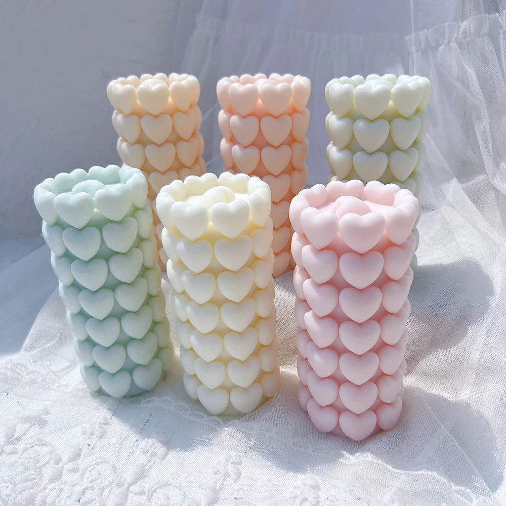 Close view of heart-shaped relief on tall pillar candles