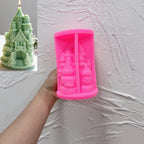Pink silicone castle mold held in a hand beside a green finished candle