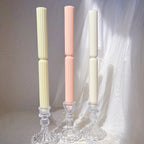 Two slender ribbed taper castings with smooth lower feet